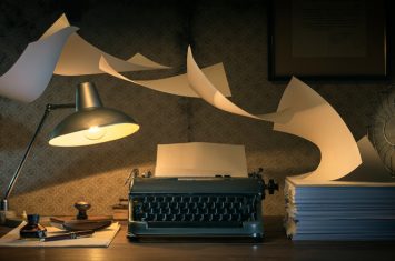 Vintage,Writer’s,Desktop,With,Typewriter,And,Flying,Sheets,,Creativity,And