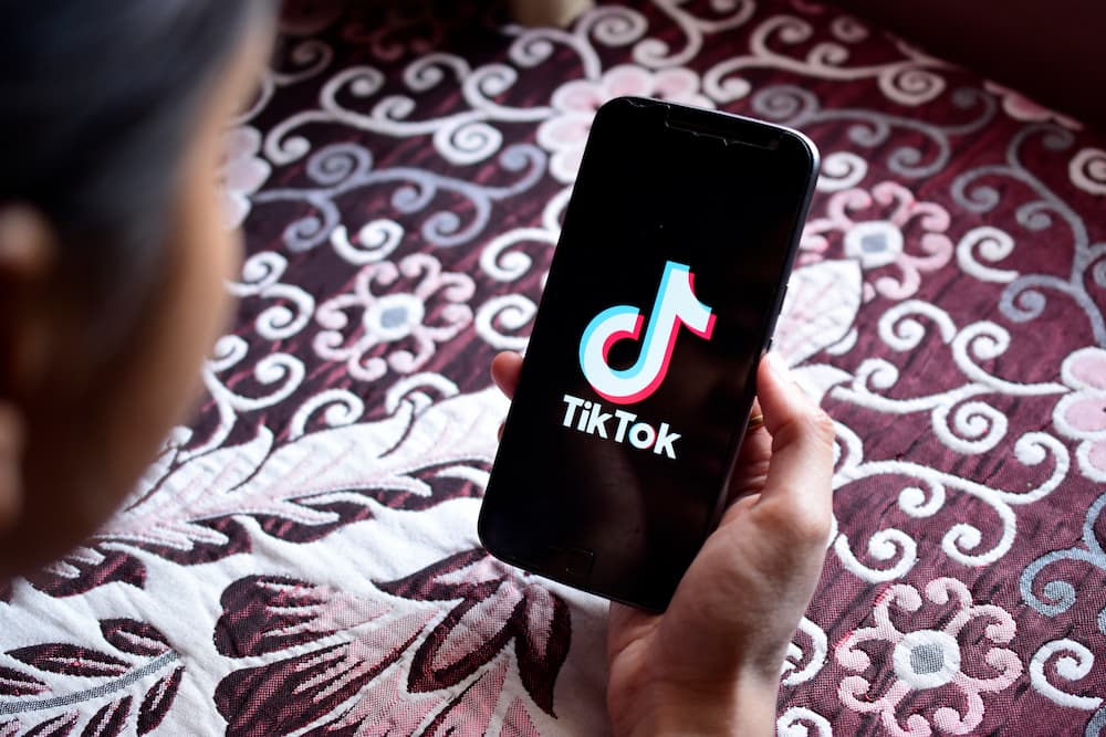 person looking at phone loading tiktok