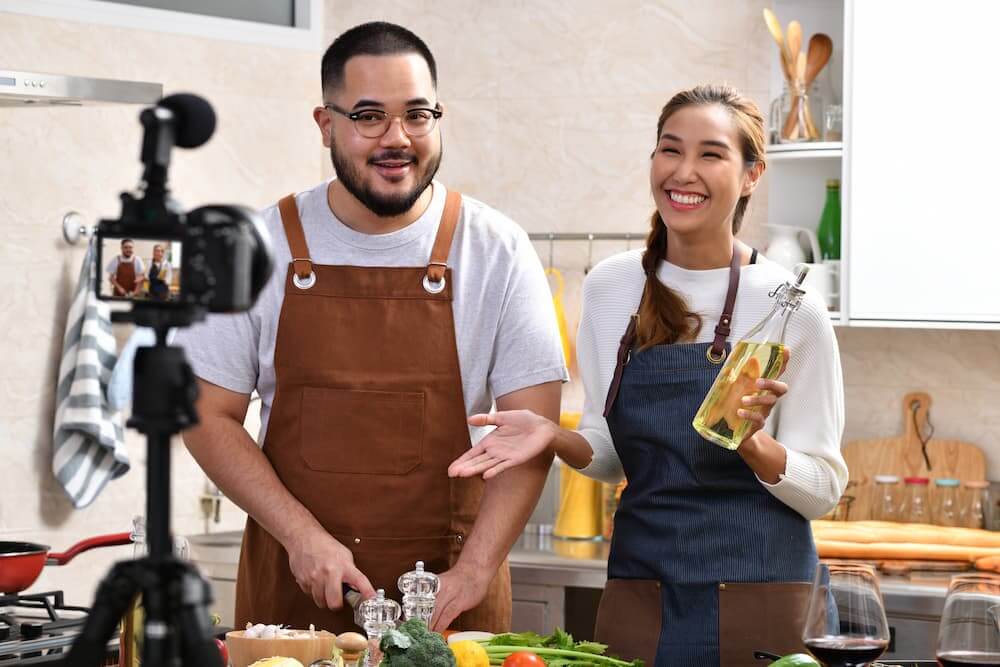 Two youtube cooks recording a video on their camera