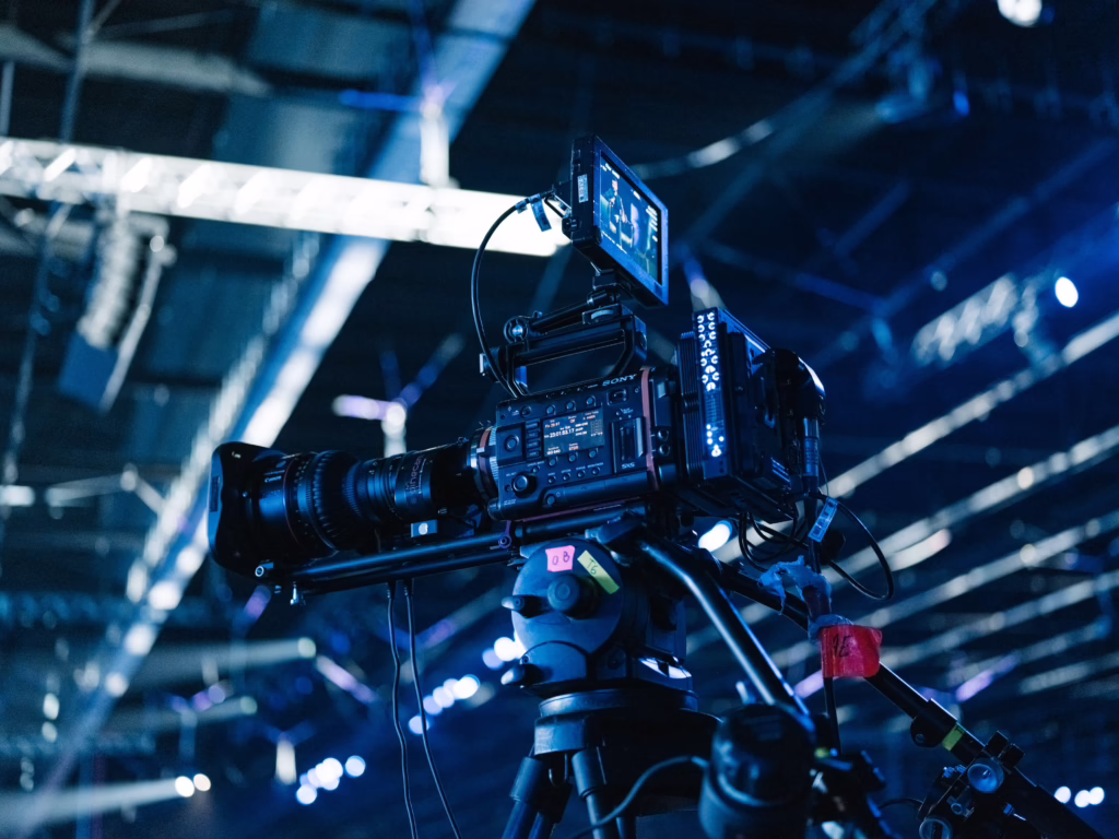 Professional broadcast camera on a tripod on a lit set, used by camera operators in TV production