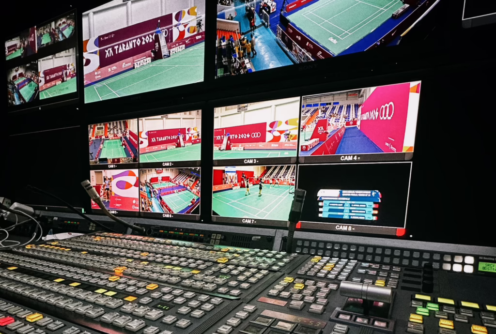 Broadcast control room with a monitor wall and vision switcher during a live sports production